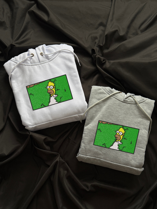 Hoodie Homero Simpson desaparece dentro de los arbustos bordado